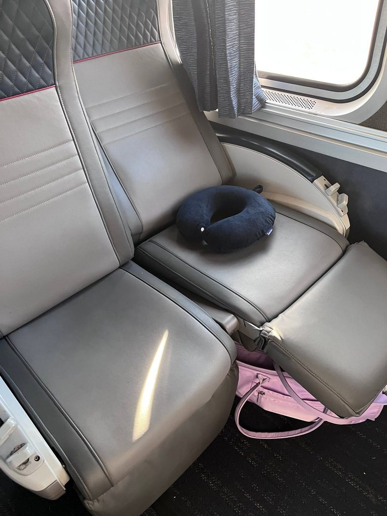 Two coach seats on Amtrak’s Empire Builder with a travel pillow during my train trip to Portland, Oregon.