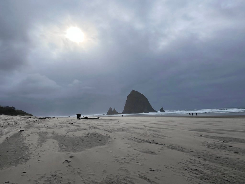 Haystack Rock on a quiet Cannon Beach in Oregon on a chilly November day.