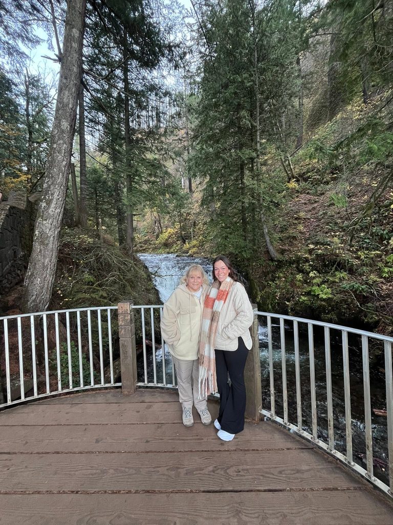Jill and Crystal standing on the viewing platform near the top of Multnomah Falls in Oregon.
