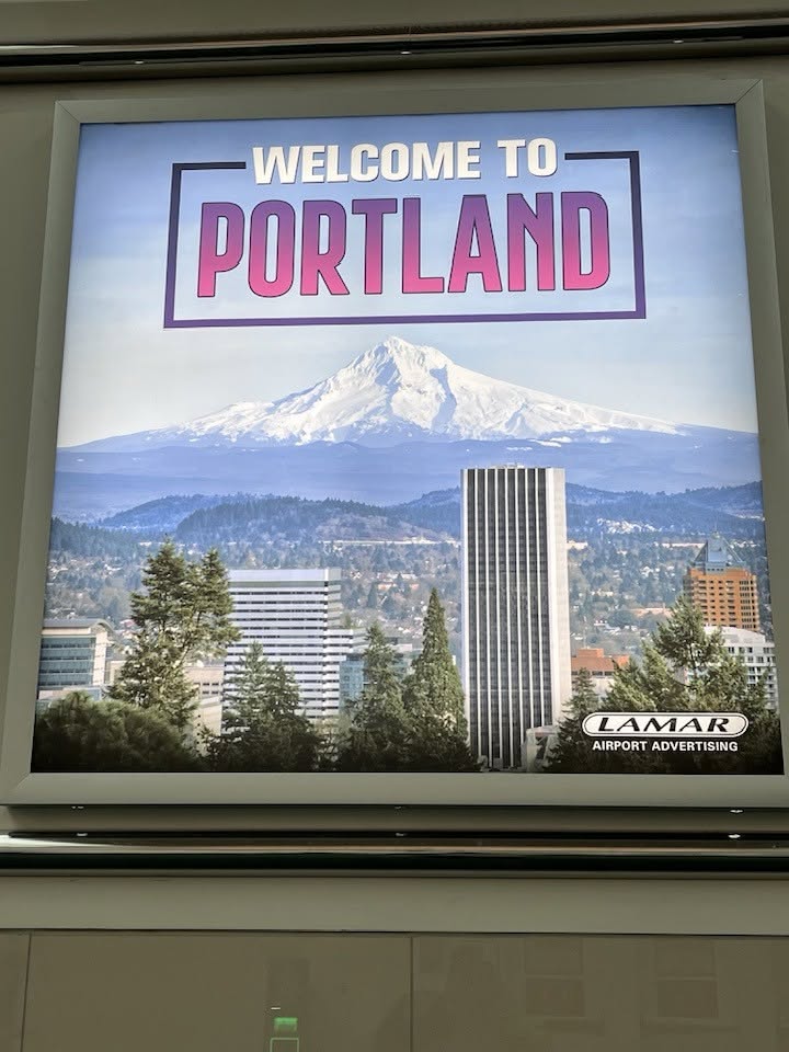 Welcome to Portland display featuring Mount Hood at Portland International Airport.